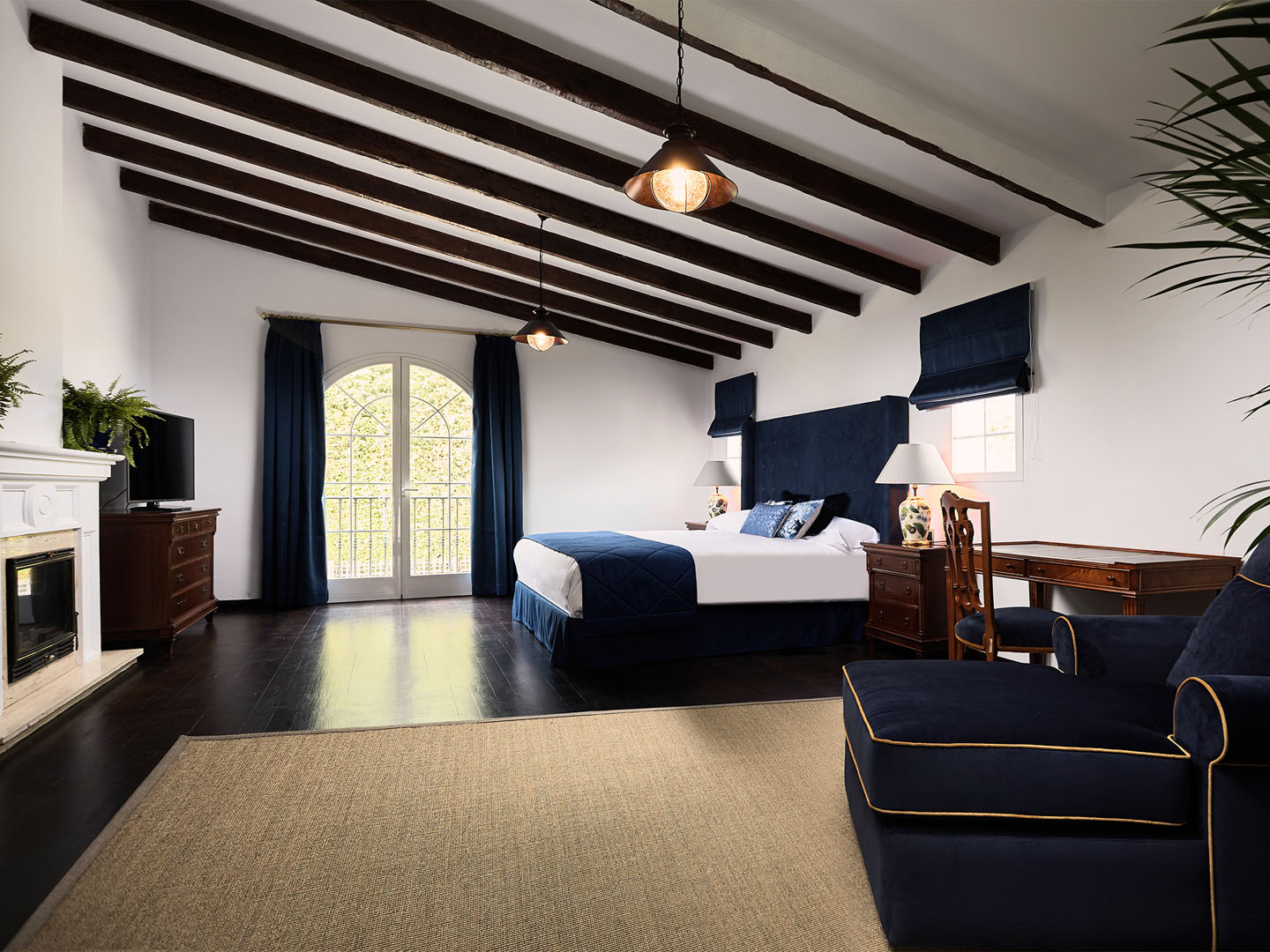 Deluxe room with beamed ceiling and fireplace
