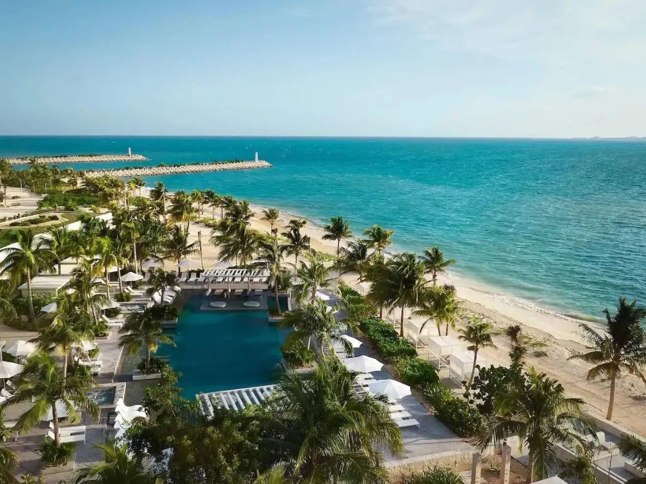 Aerial view of SLS Playa Mujeres beachfront pool and Caribbean coastline